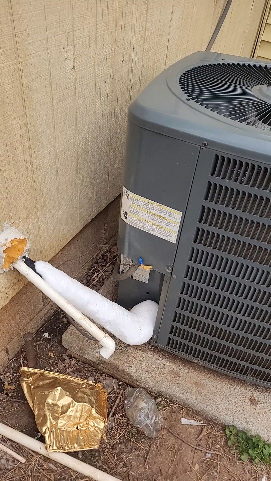 Frozen AC condenser line showing air conditioning repair issue in Oklahoma City